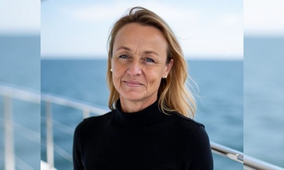 Headshot of a lady with dark blonde hair and a black jumper.